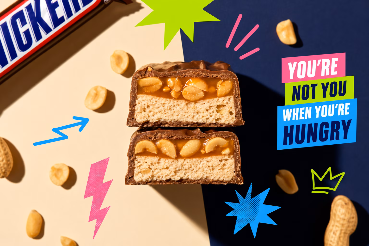Close-up of a Snickers bar cut in half showing nougat and caramel layers