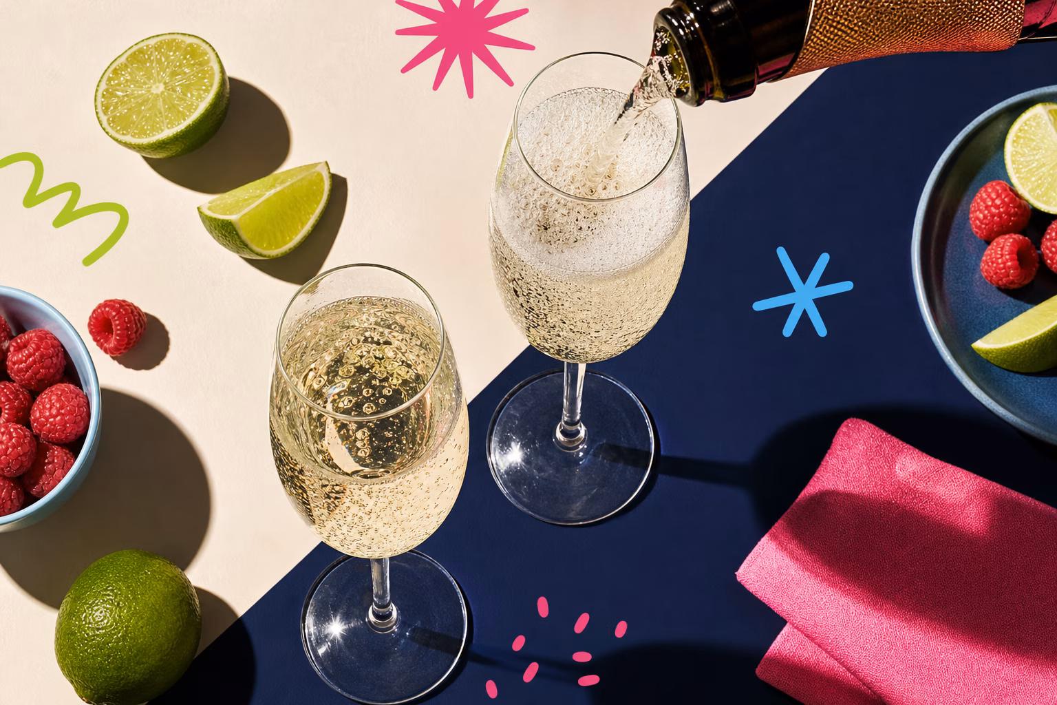 Close-up of champagne flutes being filled with bubbly